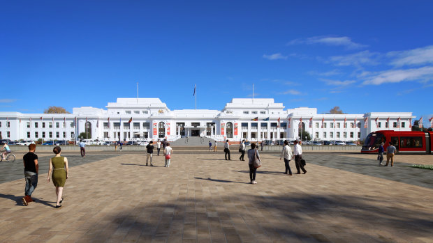 A light rail vehicle drives in front of Old Parliament House.