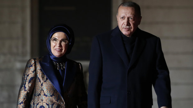 Turkey's President Recep Tayyip Erdogan and his wife Emine Erdogan arrive at an Armistice Day dinner in Paris.
