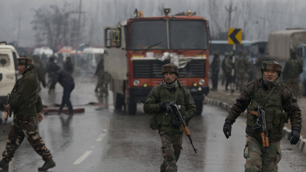 Indian paramilitary soldiers patrol near the site of an explosion in Pampore, Indian-controlled Kashmir.