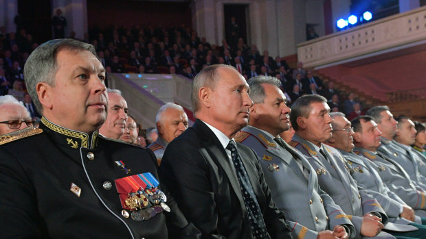 Deputy GRU chief, Vice Admiral Igor Kostyukov sits next to Russian President Vladimir Putin in 2018.