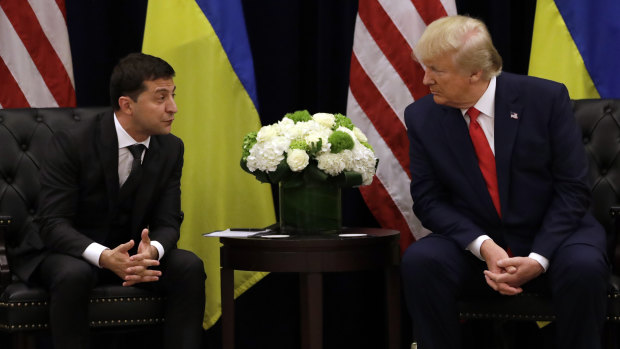 Was he or wasn't he? The impeachment inquiry is trying to ascertain if US President Donald Trump, pictured with Ukrainian President Volodymyr Zelensky in New York last month, sought to trade political help for aid. 