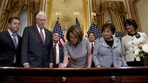 House Speaker Nancy Pelosi signs a deal to reopen the government.