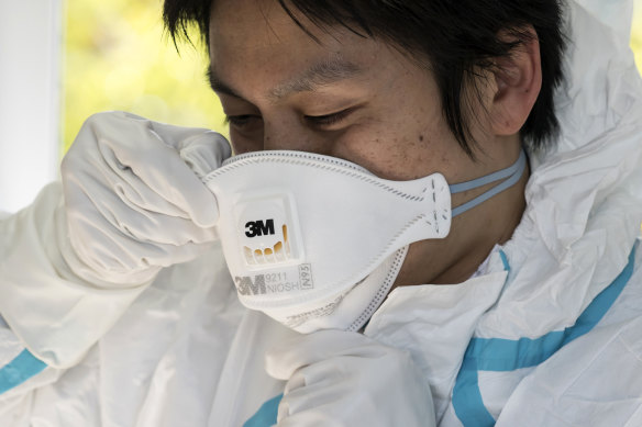 A staff member of the Yokosuka Medical Association wears an N95 mask in Japan.