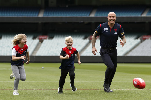 Jones plays with his children at the MCG.