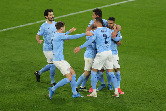 Riyah Mahrez celebrates with teammates after scoring from the penalty spot for City.