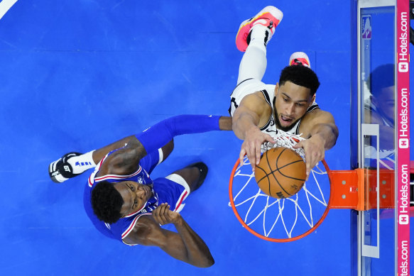 The Nets’ Ben Simmons goes for the dunk against the 76ers Paul Reed in Philadelphia.