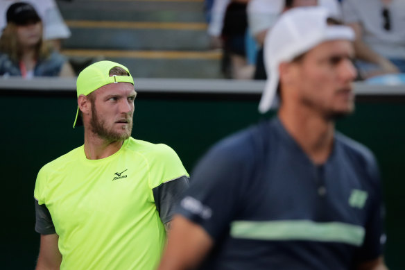 Sam Groth (left) on court with Lleyton Hewitt in 2018.