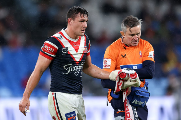 An injured Joey Manu leaves the field.