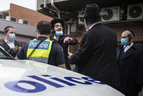 A young man argues with police outside a synagogue in Ripponlea, in Melbourne’s south east, yesterday. 