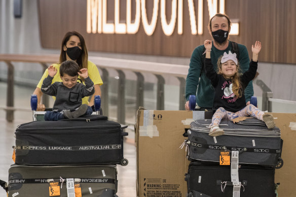 Vicky Yegen and Shayne Ryan arrive at Melbourne Airport on Monday with their children William and Talia.