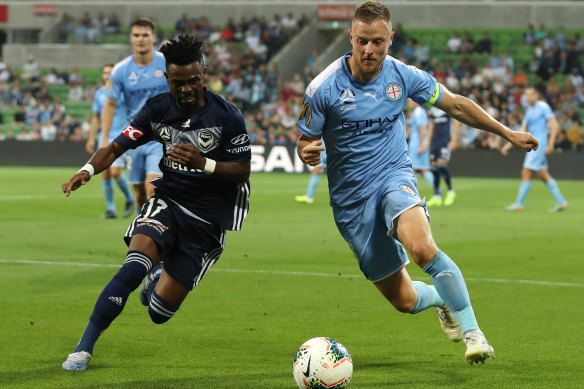 Melbourne City skipper Scott Jamieson (right) vies with Victory's Elvis Kamsoba.