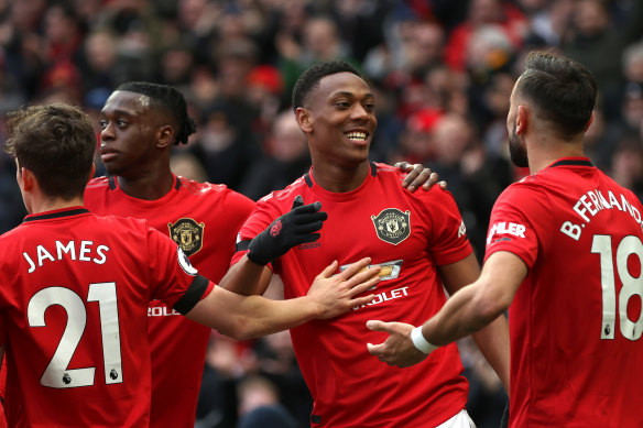 Anthony Martial celebrates with his Manchester United teammates after scoring his team's second goal against Watford at Old Trafford on Sunday.