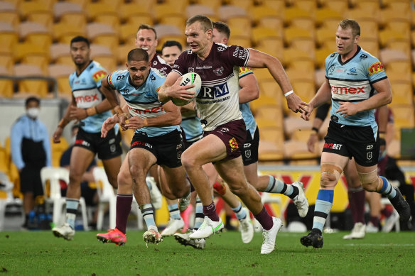 Manly fullback Tom Trbojevic races away from Sharks defenders on Monday night.