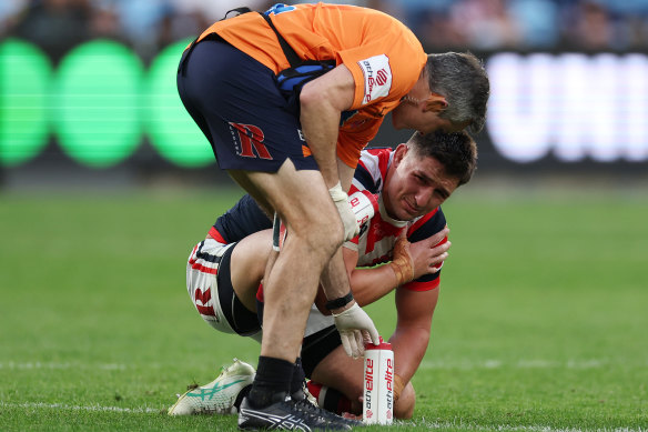 Victor Radley with a Roosters’ trainer after suffering a shoulder injury.