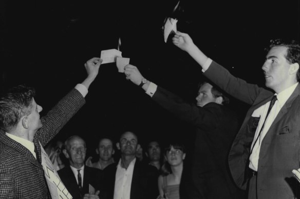 Wayne Haylen (second from right) burns his conscription card with fellow protestors Greg Barker (left) and Barry Robinson in 1966.