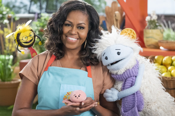 Thinking of knitting and retirement: Michelle Obama, former US first lady, with characters from the Netflix series “Waffles + Mochi”