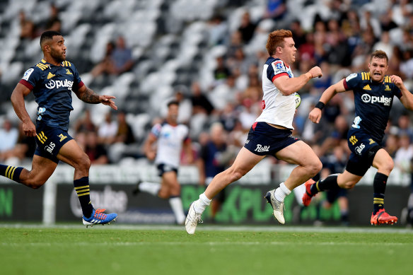 Andrew Kellaway races away to score one of his two tries for the Rebels against the Highlanders.