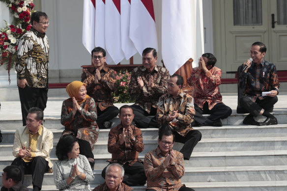 Subianto stands as he is introduced by his former rival, Widodo (right).