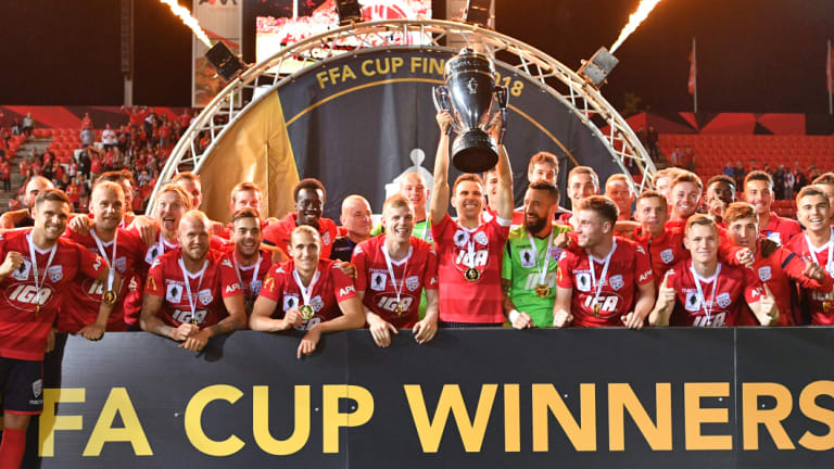 Adelaide United players celebrate after winning the FFA Cup final match against Sydney FC.