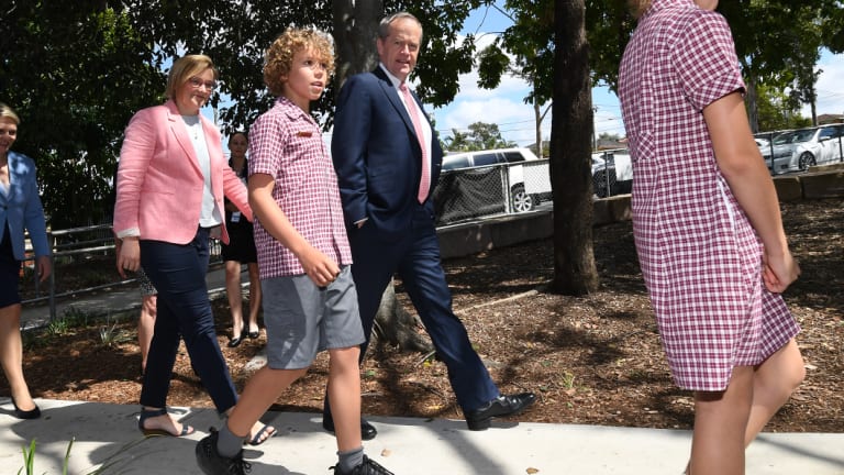 Federal Labor leader Bill Shorten walks with the party's candidate for Bonner Jo Briskey during a visit to Marsden State school in Brisbane.