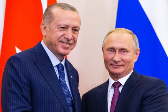Russian President Vladimir Putin, right, and Turkish President Recep Tayyip Erdogan shake hands in September.