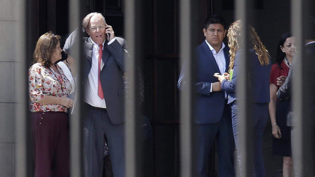 Peruvian President Pedro Pablo Kuczynski talks on his phone as he vacates the Government Palace in Lima on Wednesday.
