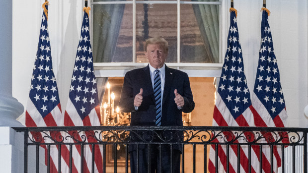 President Donald Trump gestures as he stands on the Truman Balcony of the White House in Washington, D.C., on Monday.
