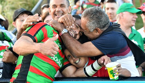 That's my boy! Souths star Cody Walker is embraced by his father Bernie after his big day on the Sunshine Coast.