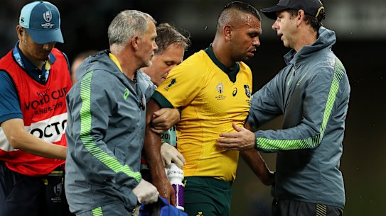 A groggy Kurtley Beale is helped off the field early in the Wallabies' clash with Georgia on Friday night.