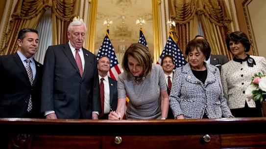House Speaker Nancy Pelosi signs a deal to reopen the government.