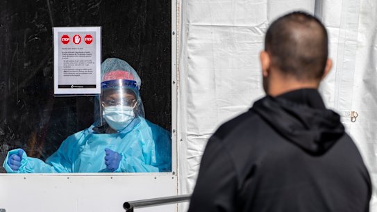 A member of the Brooklyn Hospital Center COVID-19 testing team calls in the next patient in line.