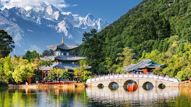 The Jade Dragon Snow Mountain peaks loom above Black Dragon Pool Park in Lijiang, China.