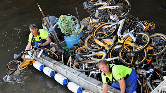 Contractors for oBike collect bicycles from Melbourne’s Yarra River.