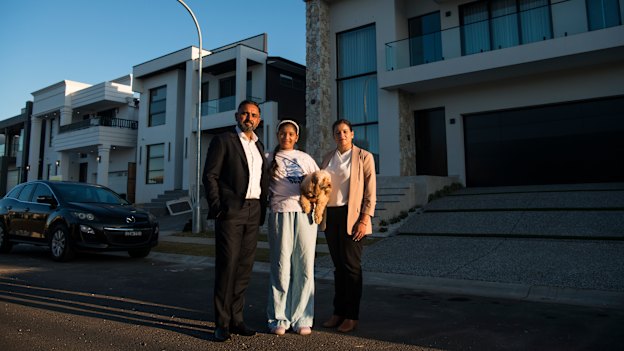 Raj and Aman Mangat with their youngest daughter Iskara (and dog, Simba) outside their home in Box Hill in Sydney’s northwestern suburbs. 