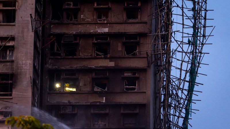 Hong Kong fire death toll rises as rescuers use torches to comb burnt-out towers