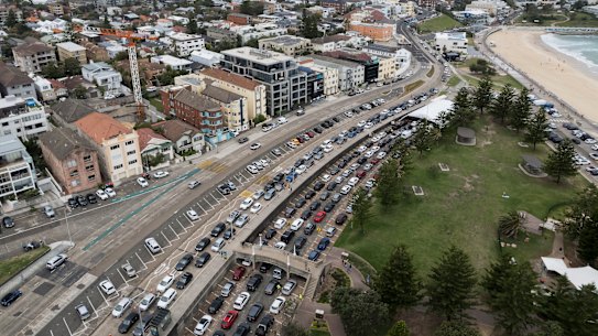 People queue for COVID-19 testing in Bondi on Monday, as the public holiday impacts opening hours for NSW clinics.