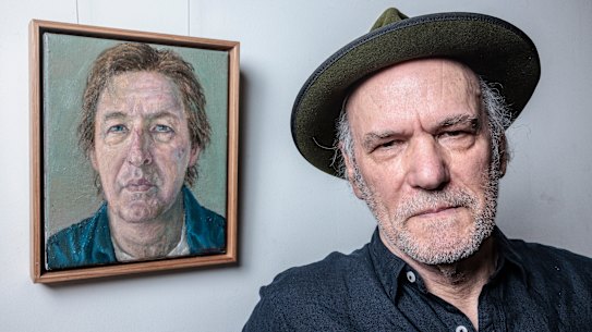 Moran prize winner Graeme Drendel poses next to his winning work “Portrait of Lewis Miller” on Wednesday.