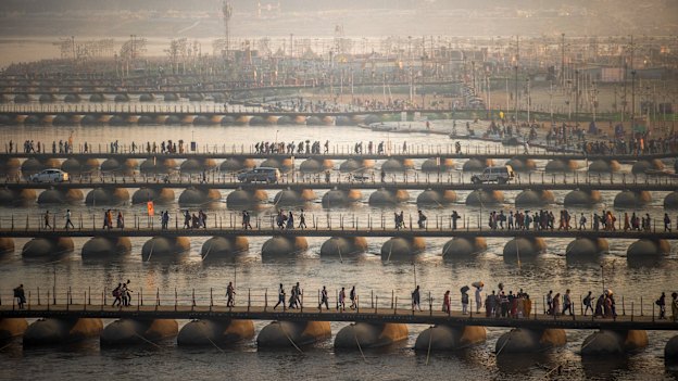 Pilgrims cross the 30 pontoon bridges built across the Ganges for the Maha Kumbh Mela this year.