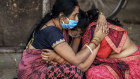 A health care worker and COVID-19 patient at a temporary treatment site in New Delhi.