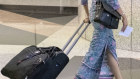 A Malaysia airlines stewardess at
Kuala Lumpur International Airport - the drop off in international travellers has hit the economy hard.