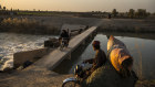 Local residents cross the Boghra Canal, in Loy Manda, an area on the outskirts of Helmand’s capital Lashkar Gah during a rare period of reduced violence. Under normal circumstances, the canal marks the frontline between government and Taliban forces. 