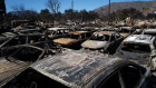 Cars destroyed by the Eaton Fire remain parked in a lot at the Altadena Auto Centre. 