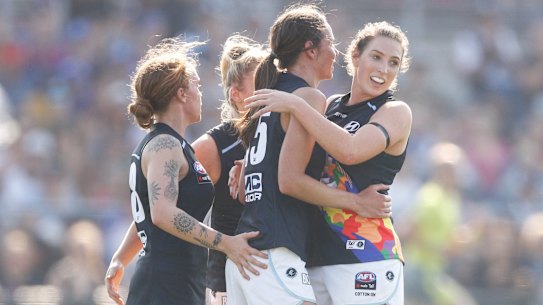 Carlton players celebrate a goal against the Western Bulldogs.