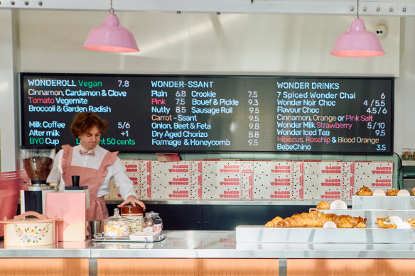 Staff at Baked Wonder in Burwood East wear frilly pink uniforms.