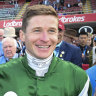 J-Mac sticks neck out over ‘ridiculous’ skivvy logo ban; Victorian racing codes lose $58m
