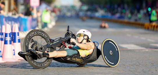 Lauren Parker makes her way down the Champs-Elysees in the triathlon.