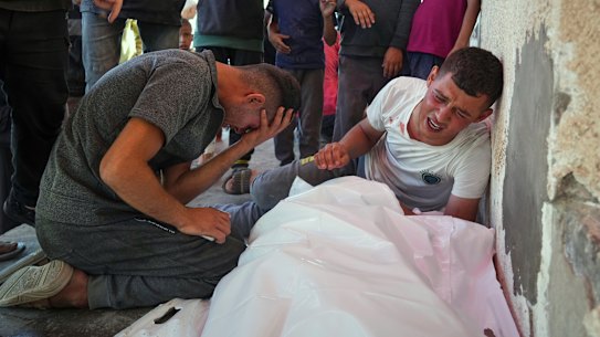 Relatives mourn after 10 people, including several children, were killed in an Israeli strike while they were waiting to receive nutritional supplements at a Project Hope-run medical clinic in Deir al-Balah on Thursday.