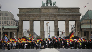 AfD supporters wave flags in front of the Brandenburg Gate in Berlin, Germany, in  May.