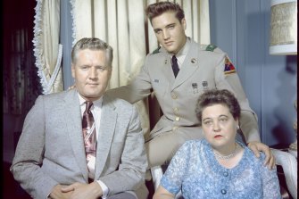 Elvis Presley photographed at Graceland with parents Vernon and Gladys in June 1958.
