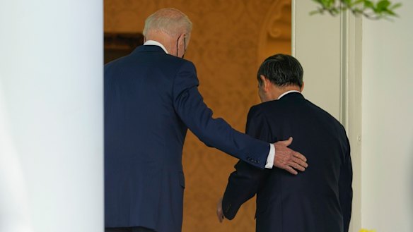US President Joe Biden, accompanied by Japanese Prime Minister Yoshihide Suga, walk back into the Oval Office after a news conference in the Rose Garden of the White House in Washington.